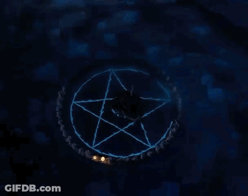 An Aerial View Of A Person In A Pentagram With Candles Around Them . GIF