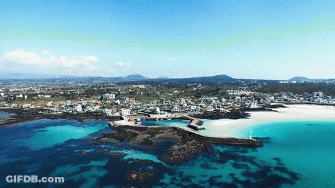 An Aerial View Of A Small Town On A Small Island In The Middle Of The Ocean GIF