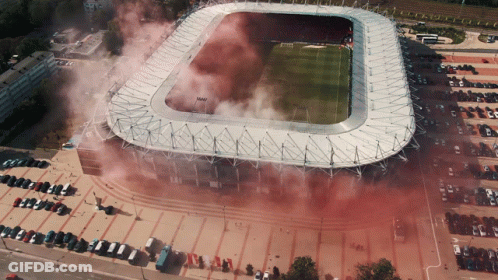 An Aerial View Of A Soccer Stadium With Smoke Coming Out Of It GIF