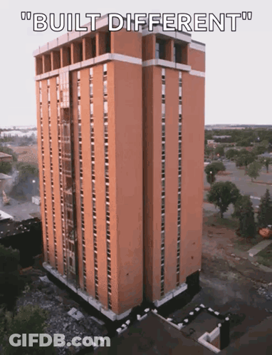 An Aerial View Of A Tall Building With The Words " Built Different " Below It GIF