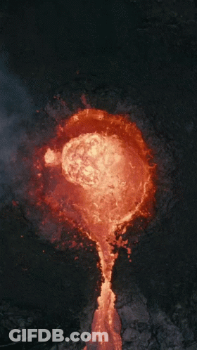 An Aerial View Of A Volcano With Lava Coming Out Of The Crater GIF