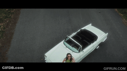 An Aerial View Of A Woman In A White Convertible With Gifrun.com Written Below It GIF