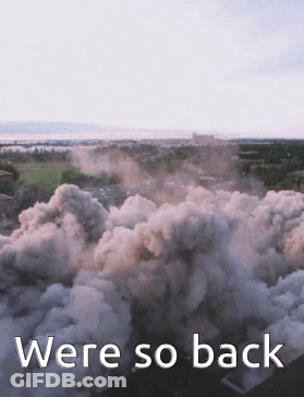 An Aerial View Of Smoke Coming Out Of A Building With The Words Were So Back Below It GIF