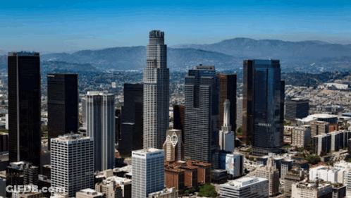 An Aerial View Of The City Of Los Angeles With A Few Mountains In The Background GIF