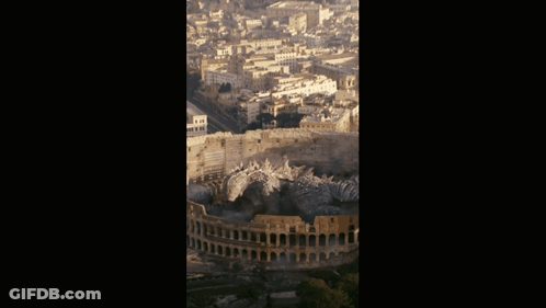 An Aerial View Of The Colosseum In Rome With A City In The Background GIF