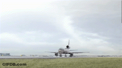 An Airplane Is Taking Off From A Runway With A Cloudy Sky Behind It GIF