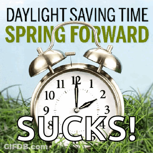 An Alarm Clock Is Sitting In The Grass With The Words Daylight Saving Time Spring Forward Sucks GIF