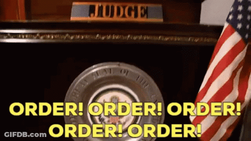An American Flag Is In Front Of A Judge 'S Desk With The Words Order Order Order Order GIF