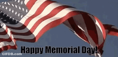 An American Flag Is Waving In The Wind With The Words `` Happy Memorial Day '' Below It . GIF