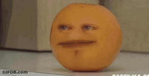 An Apple With A Face On It Is Sitting On A Table GIF