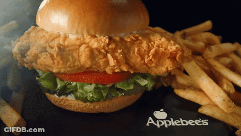 An Applebee 'S Chicken Sandwich With French Fries On The Side GIF