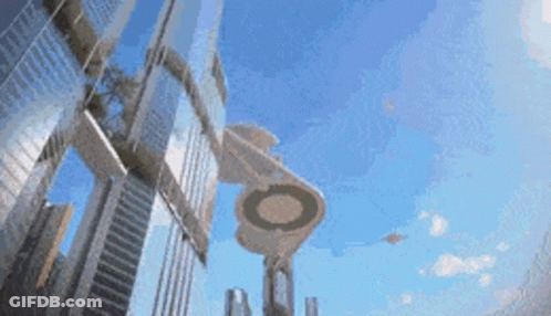 An Artist 'S Impression Of A Futuristic City With A Ufo Flying Overhead GIF