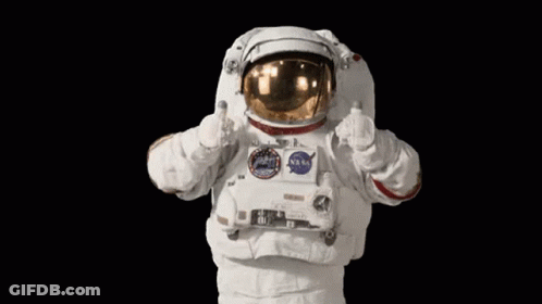 An Astronaut Is Giving A Thumbs Up Sign While Wearing A Nasa Space Suit . GIF