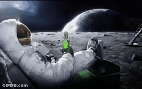 An Astronaut Is Sitting On The Moon Drinking A Beer . GIF