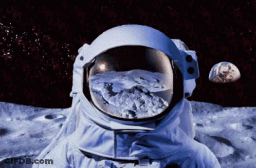 An Astronaut Stands On The Moon Looking At The Earth GIF