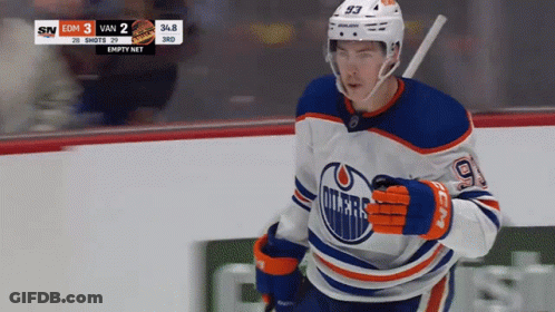 An Edmonton Oilers Hockey Player Runs On The Ice GIF