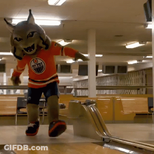 An Edmonton Oilers Mascot Playing Bowling In A Bowling Alley GIF