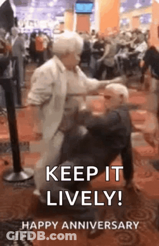 An Elderly Couple Is Dancing In A Crowded Room And A Man Is Sitting On A Woman 'S Lap . GIF