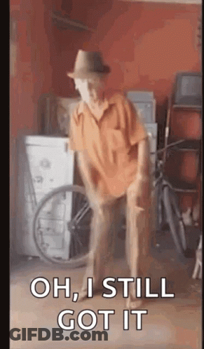 An Elderly Man In A Hat Is Dancing In A Garage With A Bicycle In The Background . GIF