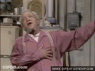 An Elderly Man In A Pink Jacket Is Standing In Front Of A Refrigerator With His Arms Outstretched . GIF