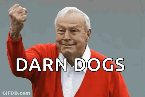 An Elderly Man In A Red Sweater Holds His Fist Up In The Air With The Words Darn Dogs Below Him GIF