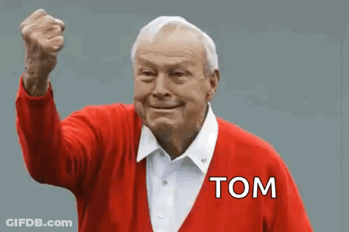 An Elderly Man In A Red Sweater With The Word Tom On It GIF