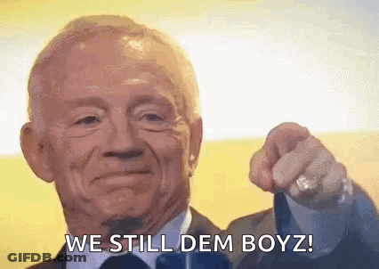 An Elderly Man In A Suit And Tie Is Pointing At The Camera And Saying `` We Still Dem Boyz '' . GIF