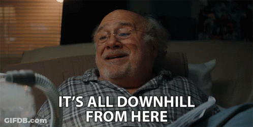 An Elderly Man Is Laying On A Couch With The Words " It 'S All Downhill From Here " Above Him GIF