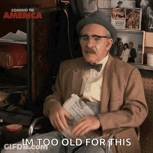 An Elderly Man Sitting In A Chair Holding A Newspaper With The Words Im Too Old For This Below Him GIF