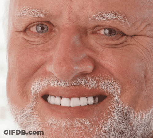 An Elderly Man With A Beard And White Teeth Smiles GIF