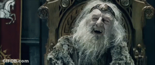 An Elderly Man With A Beard Is Sitting On A Throne And Smiling . GIF