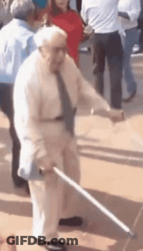 An Elderly Man With A Cane Is Dancing In A Crowd GIF