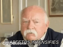 An Elderly Man With A Mustache Is Sitting In A Living Room And Saying `` Diabetes Intensifies '' . GIF