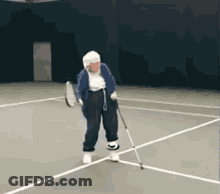 An Elderly Woman Holding A Tennis Racquet On A Tennis Court GIF