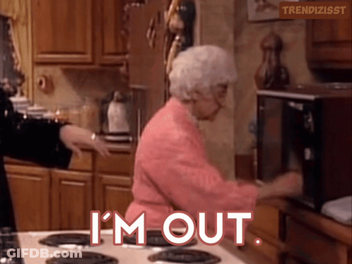 An Elderly Woman In A Pink Robe Is Standing In Front Of A Microwave And Says " I 'M Out " GIF
