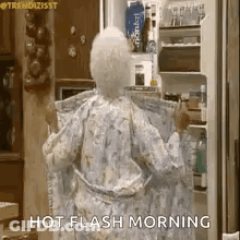 An Elderly Woman In A Robe Is Standing In Front Of A Refrigerator . GIF
