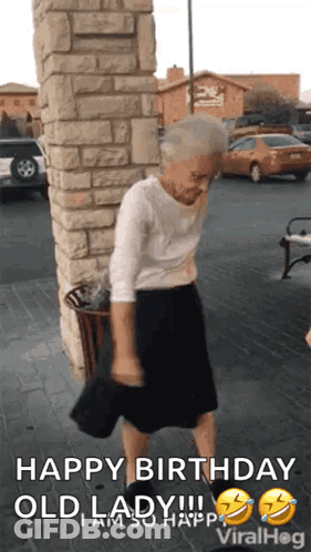 An Elderly Woman Is Dancing In Front Of A Brick Wall With The Caption Happy Birthday Old Lady I Am So Happy . GIF