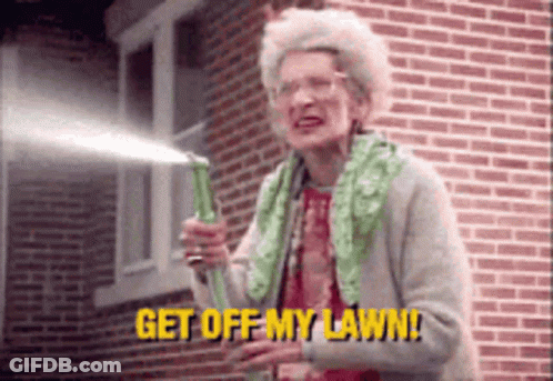 An Elderly Woman Is Holding A Green Hose And Says Get Off My Lawn GIF