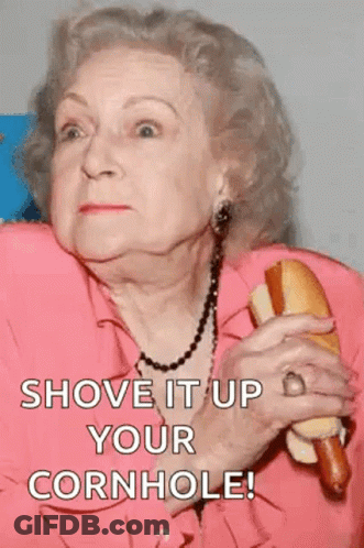 An Elderly Woman Is Holding A Hot Dog In Her Hand And Says Shove It Up Your Cornhole ! GIF