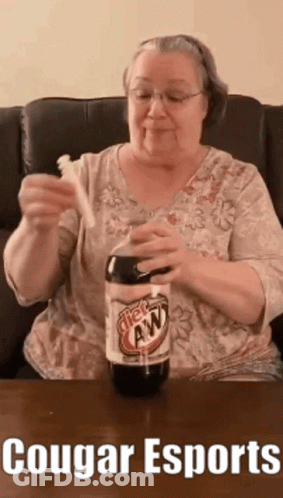An Elderly Woman Is Holding A Toothbrush And A Bottle Of Root Beer .. GIF