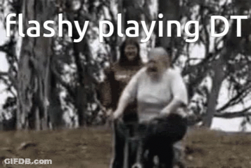 An Elderly Woman Is Riding A Bicycle In A Park While A Man Watches . GIF