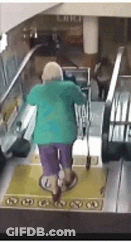 An Elderly Woman Is Riding An Escalator With A Cane . GIF