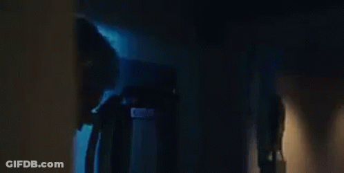 An Elderly Woman Is Sitting In A Chair With The Words `` The Temptations '' Written Above Her . GIF
