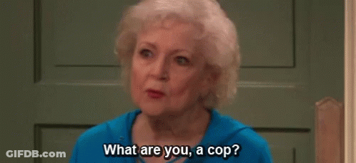 An Elderly Woman Is Sitting In Front Of A Door And Talking To Someone . GIF