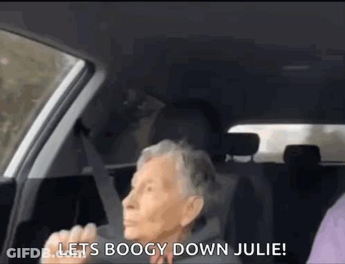 An Elderly Woman Is Sitting In The Back Seat Of A Car And Shouting . GIF