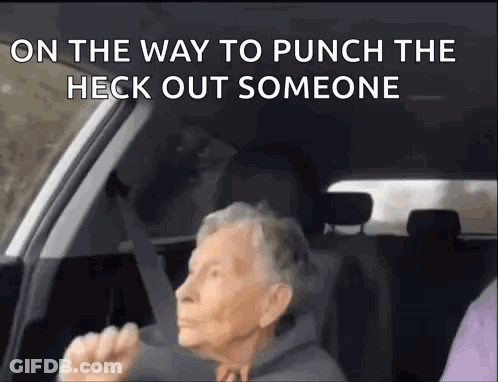 An Elderly Woman Is Sitting In The Driver 'S Seat Of A Car And Yelling . GIF