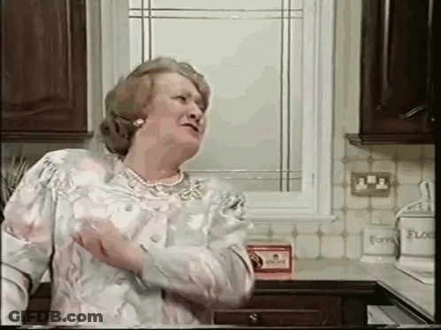 An Elderly Woman Is Standing In A Kitchen With A Box Of Flour On The Counter GIF