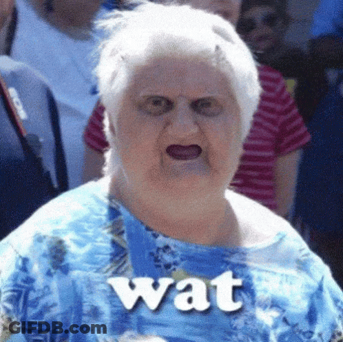 An Elderly Woman Wearing A Blue Shirt Has The Word Wat On Her Shirt GIF