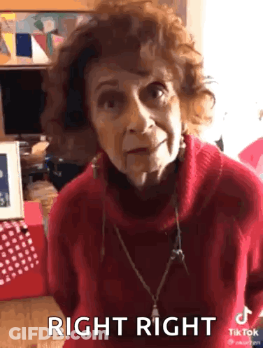 An Elderly Woman Wearing A Red Sweater Is Making A Funny Face And Says Right Right . GIF