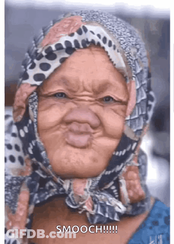 An Elderly Woman Wearing A Scarf On Her Head Making A Funny Face . GIF
